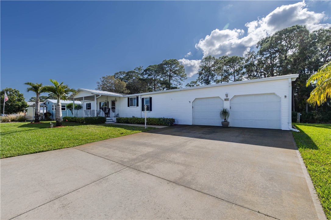 327 Papaya Circle Sebastian, FL 32976 - Photo 4 of 32 a view of a house with a backyard and a garage