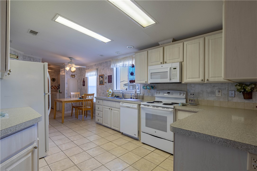 327 Papaya Circle Sebastian, FL 32976 - Photo 7 of 32 a kitchen with appliances cabinets and furniture