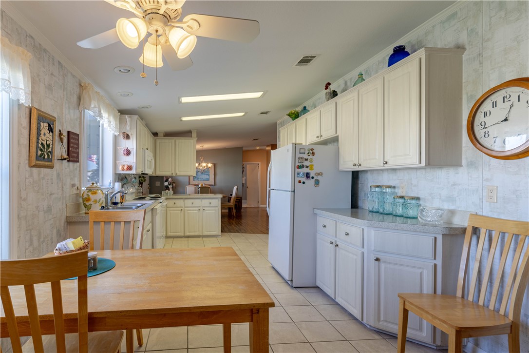 327 Papaya Circle Sebastian, FL 32976 - Photo 8 of 32 a kitchen with cabinets a center island stainless steel appliances and cabinets