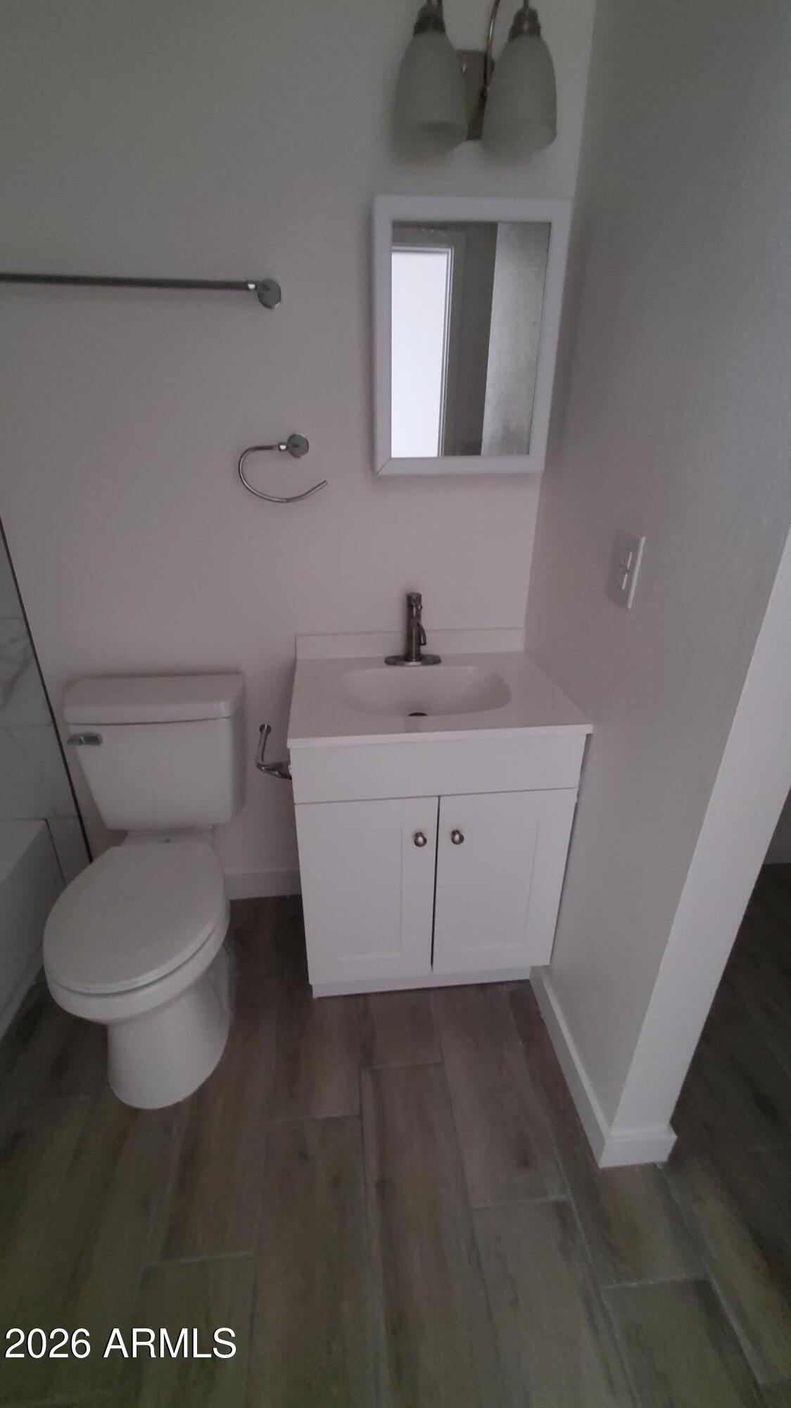 302 South Westfall Avenue, Unit 2 Tempe, AZ 85281 - Photo 12 of 19 a white toilet sitting next to a bathroom sink