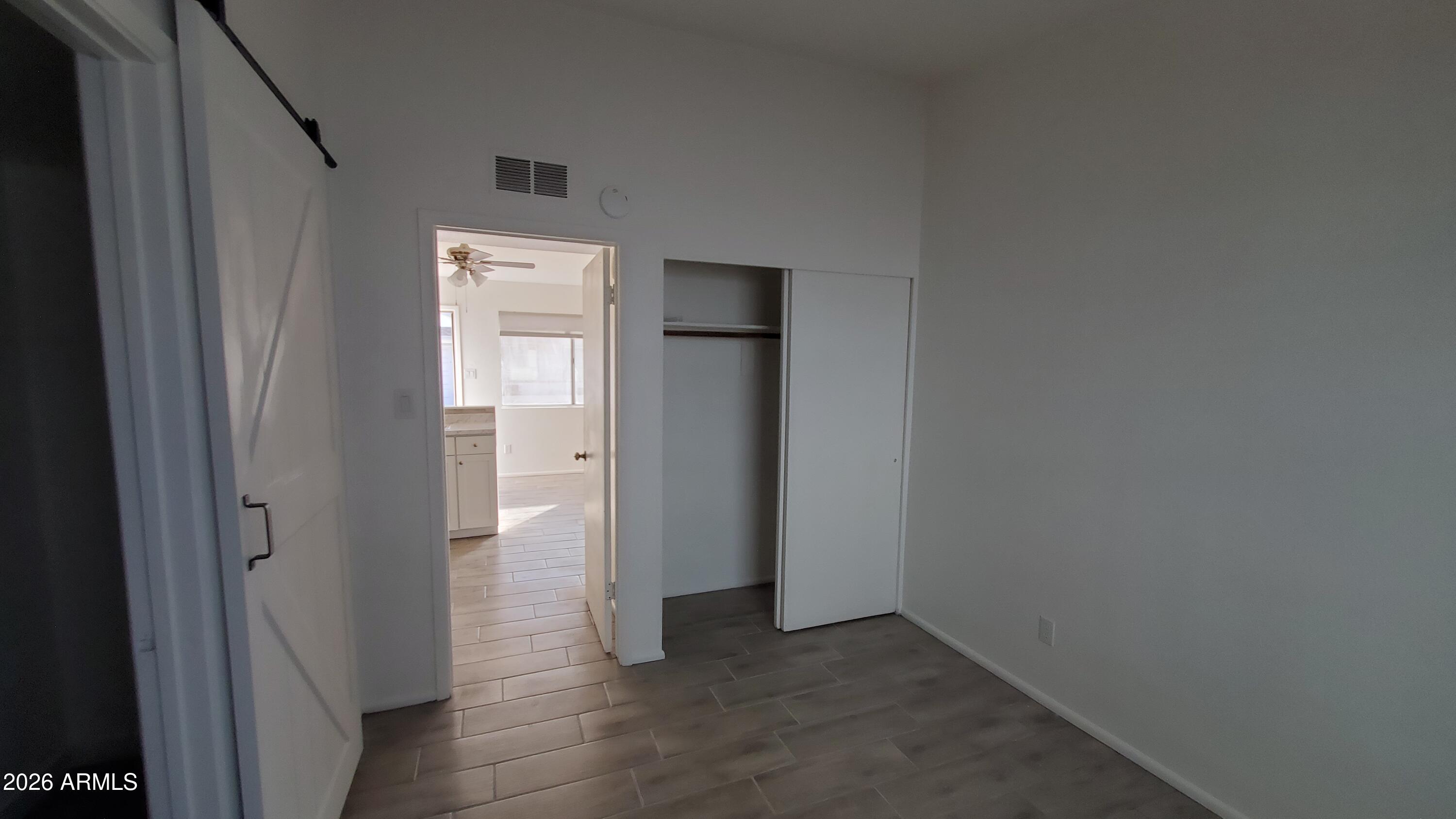 302 South Westfall Avenue, Unit 2 Tempe, AZ 85281 - Photo 16 of 19 an empty room with closet and wooden door