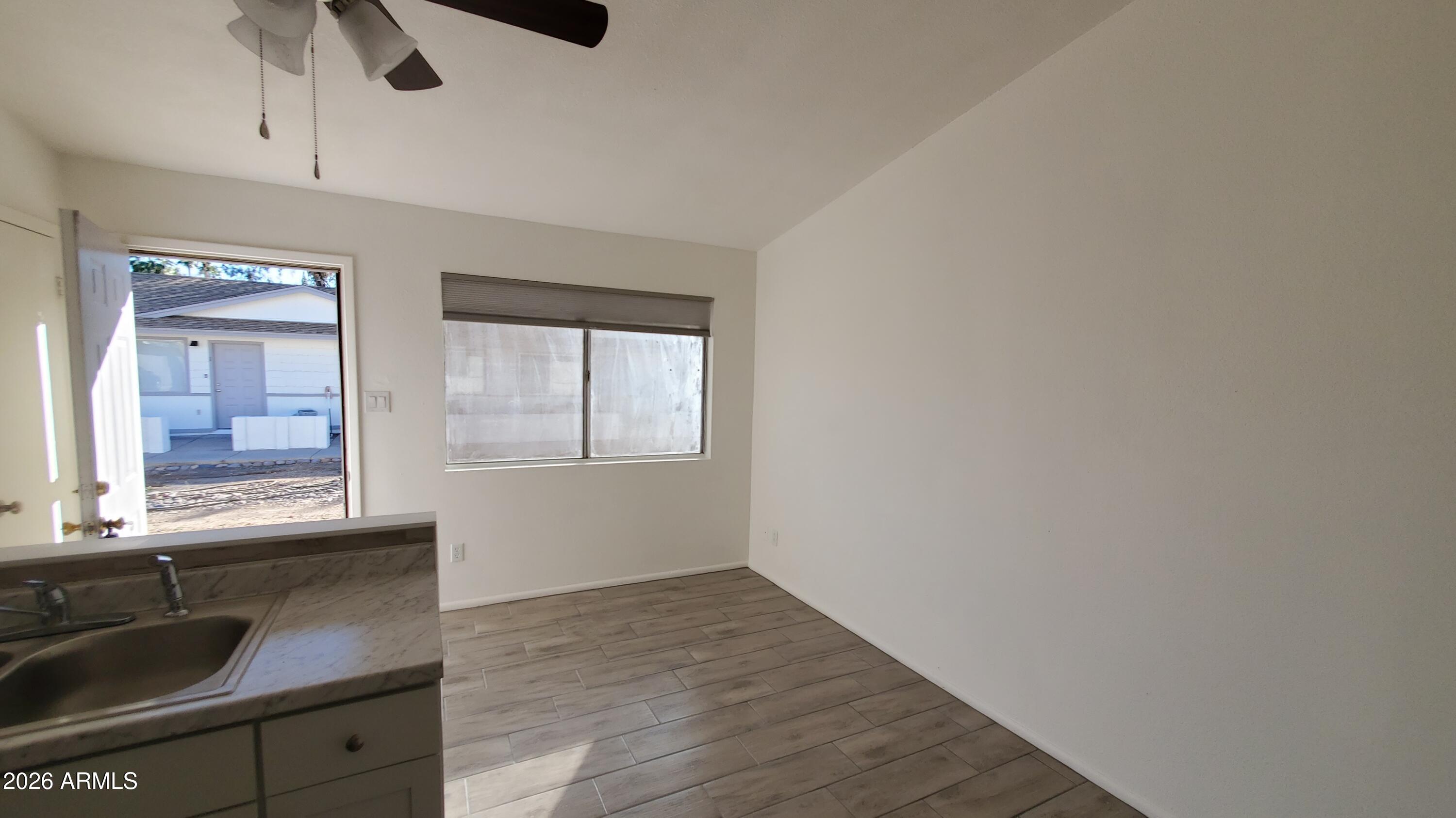 302 South Westfall Avenue, Unit 2 Tempe, AZ 85281 - Photo 6 of 19 wooden floor in an empty room with a window