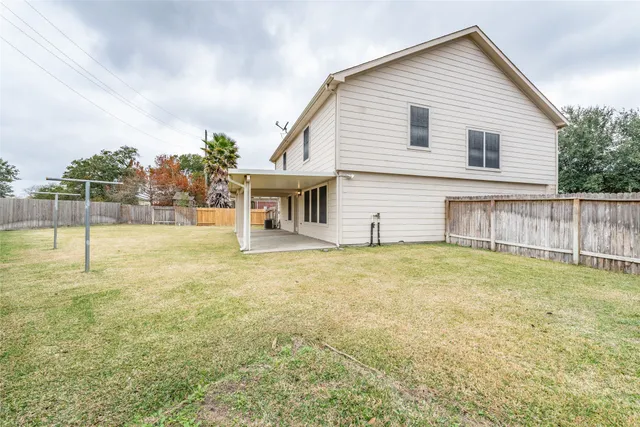 a view of a house with a yard and sitting area