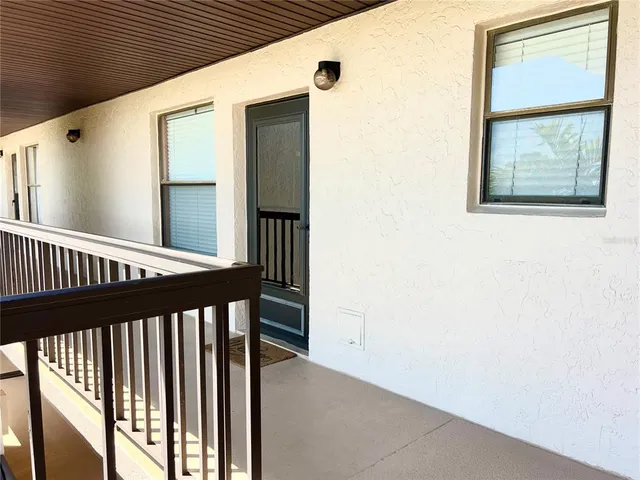 a view of a porch with wooden floor