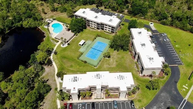 an aerial view of residential house with outdoor space and parking