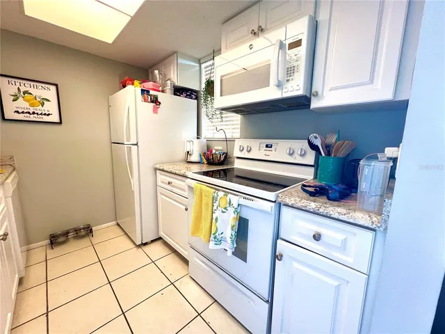 a kitchen with a refrigerator a stove a microwave and cabinets