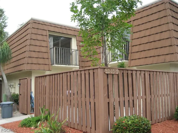 a side view of a house with a small yard