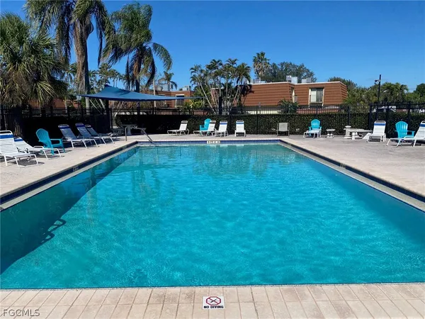 a swimming pool with outdoor seating and yard