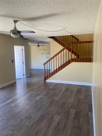 a view of staircase with railing and white walls