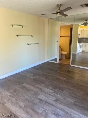a view of a room with wooden floor