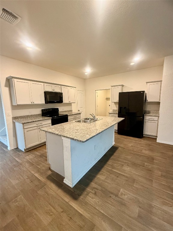 19101 Romano Drive Elgin, TX 78621 - Photo 12 of 36 a large kitchen with kitchen island a sink a counter top space and stainless steel appliances