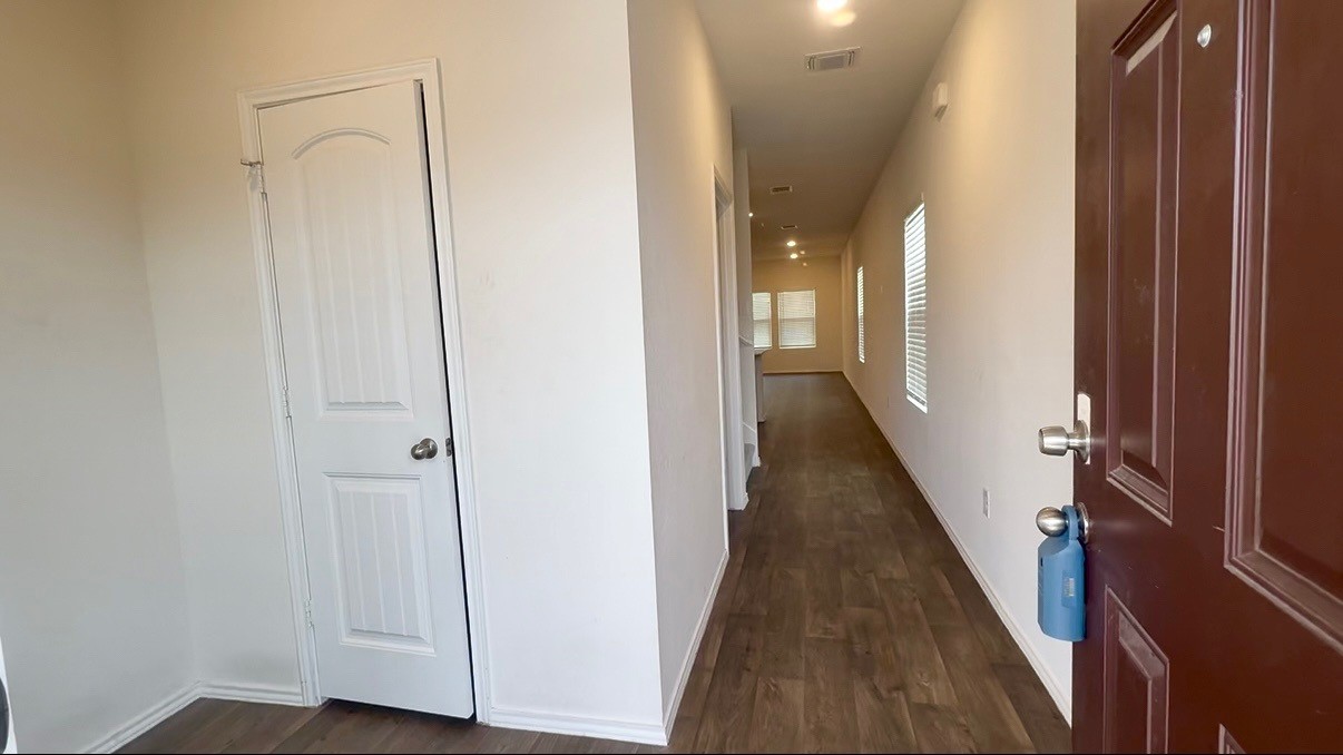 19101 Romano Drive Elgin, TX 78621 - Photo 4 of 36 a view of a hallway with wooden floor