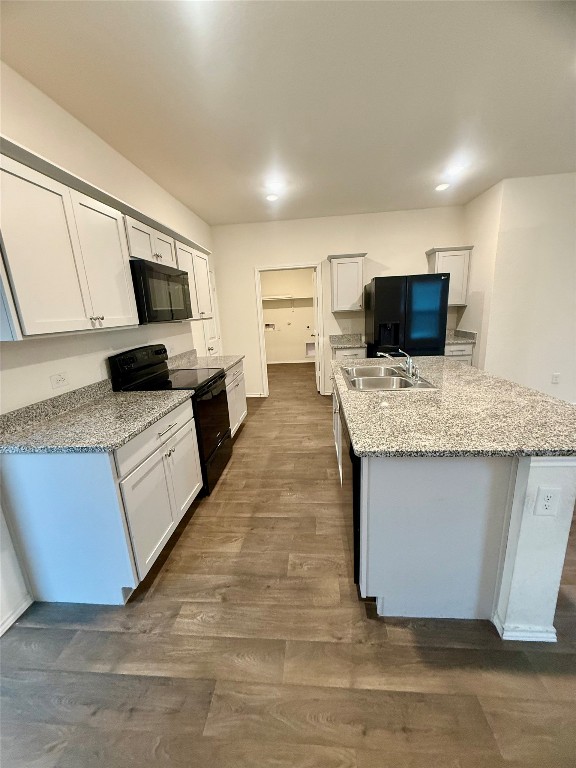 19101 Romano Drive Elgin, TX 78621 - Photo 9 of 36 a large kitchen with granite countertop a sink and a stove top oven