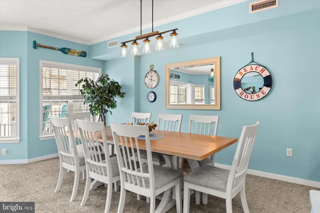 a living room with furniture kitchen view and a large window