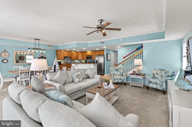 a living room with fireplace furniture and a large window
