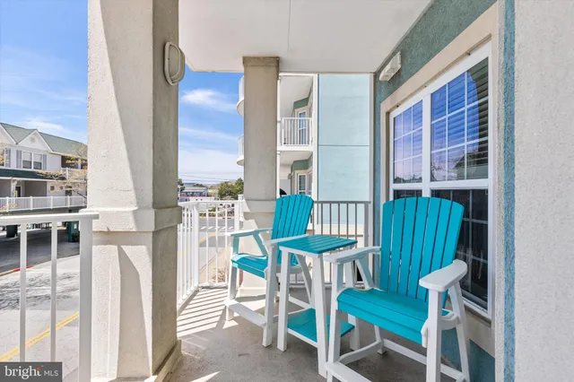 a living room with furniture a chandelier and a flat screen tv