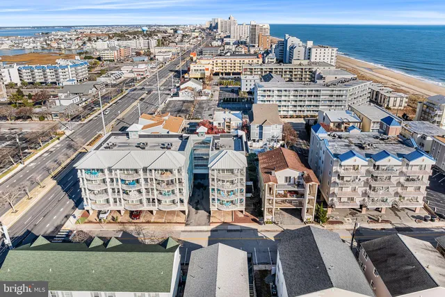 an aerial view of multiple houses with yard