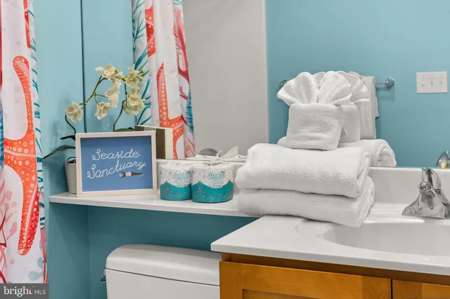 a bathroom with double vanity sinks a vanity a lamp and a mirror