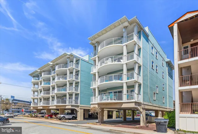 a dining area with a table chairs and a painting