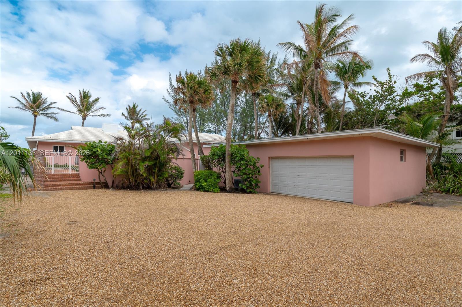55 North Beach Road Jupiter Island, FL 33455 - Photo 33 of 56 a view of a house with a large tree and a yard
