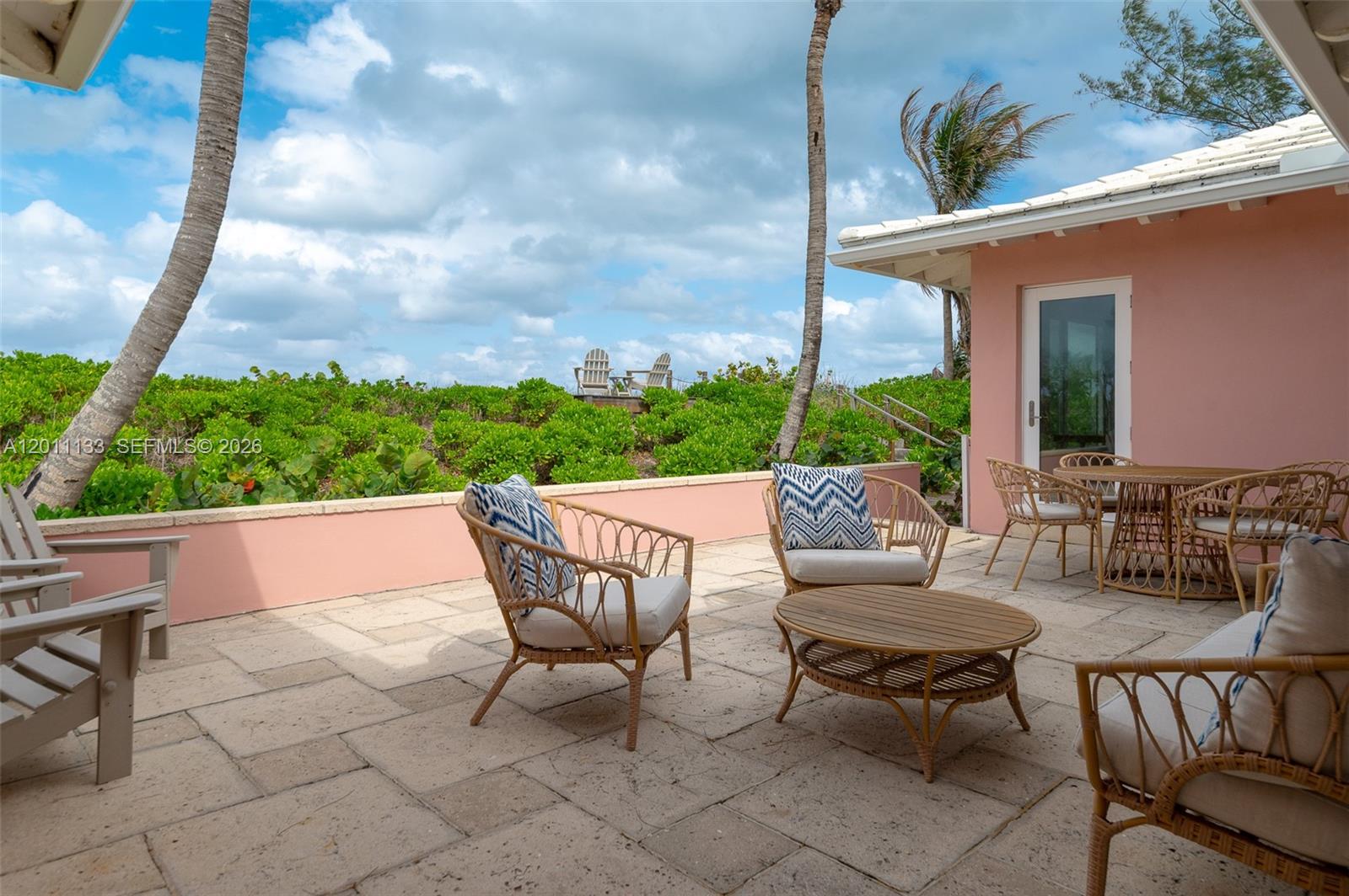 55 North Beach Road Jupiter Island, FL 33455 - Photo 36 of 56 a view of a patio with a table and chairs