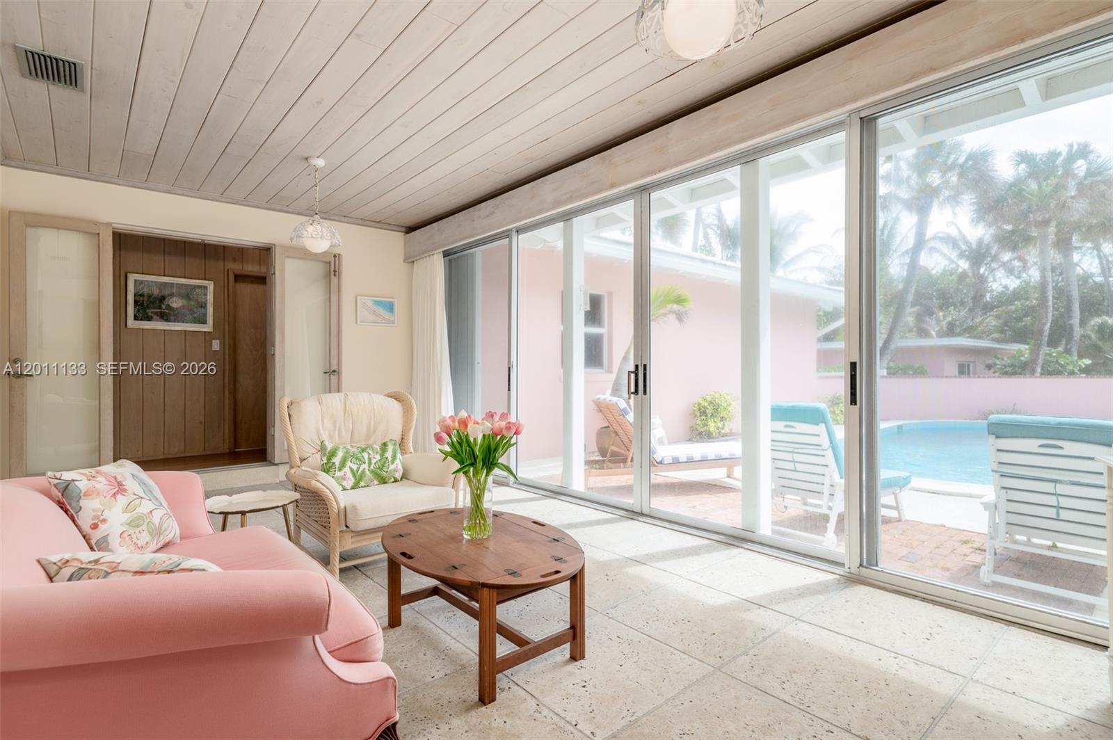 55 North Beach Road Jupiter Island, FL 33455 - Photo 39 of 56 a living room with furniture and a floor to ceiling window