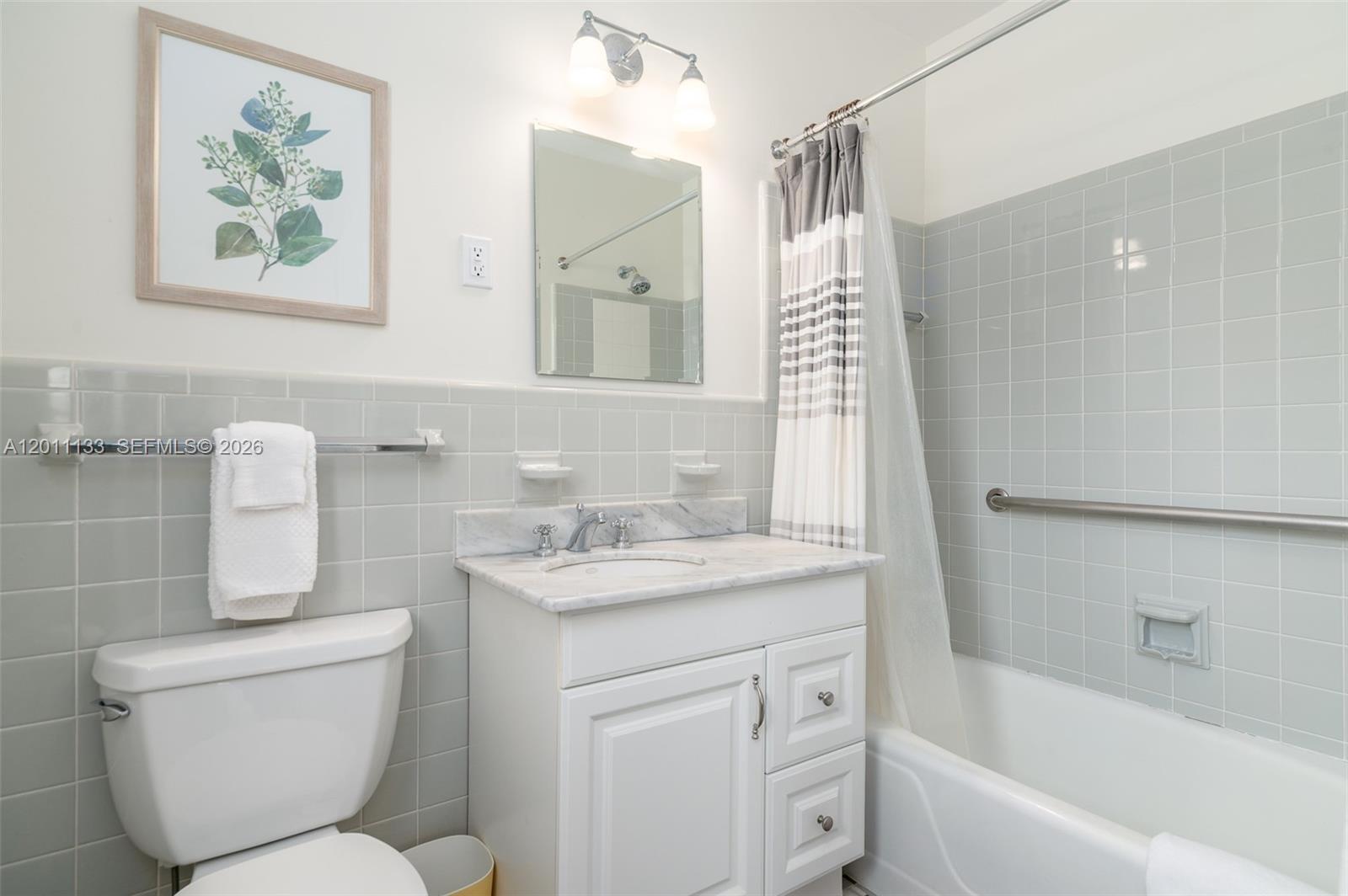 55 North Beach Road Jupiter Island, FL 33455 - Photo 42 of 56 a bathroom with a toilet sink and mirror