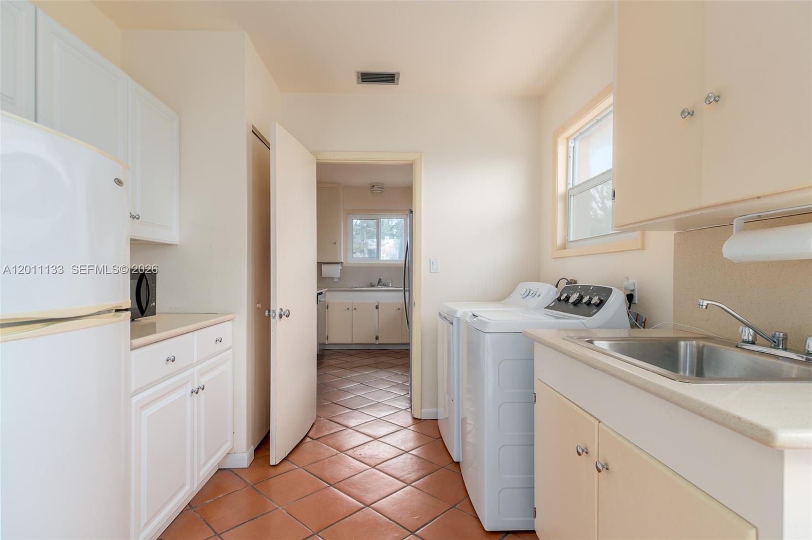 55 North Beach Road Jupiter Island, FL 33455 - Photo 52 of 56 a room with a sink and a washer dryer