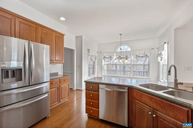 a kitchen with stainless steel appliances a refrigerator and a sink