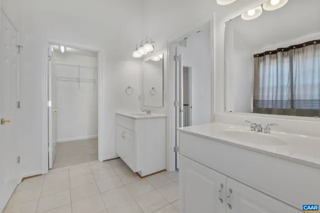 a spacious bathroom with a shower sink and mirror