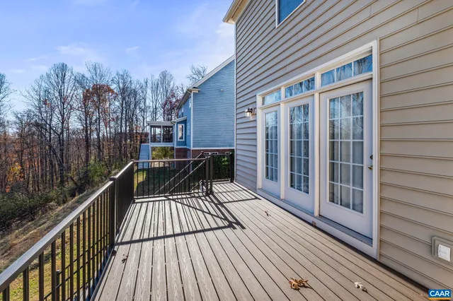 a view of balcony with wooden floor and fence