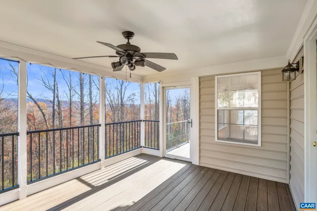 a view of a room with wooden floor and window