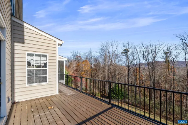 a view of a balcony with wooden floor and fence