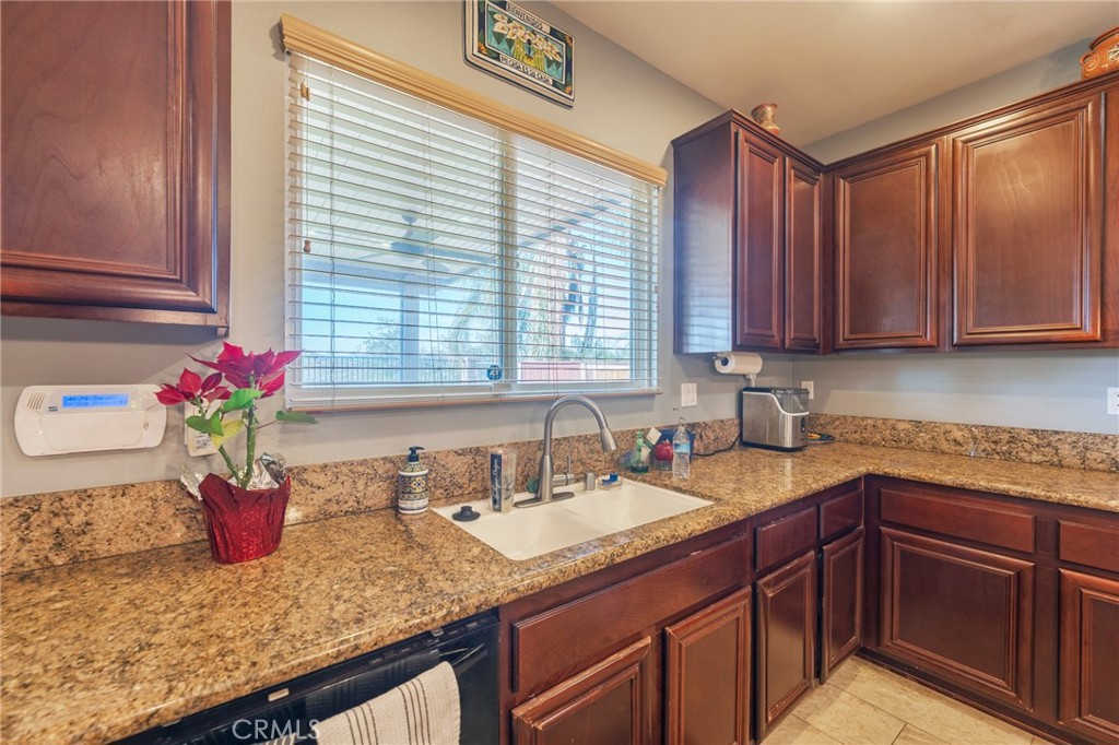 17073 Spring Canyon Place Riverside, CA 92503 - Photo 12 of 43 a kitchen with stainless steel appliances granite countertop a sink dishwasher and cabinets