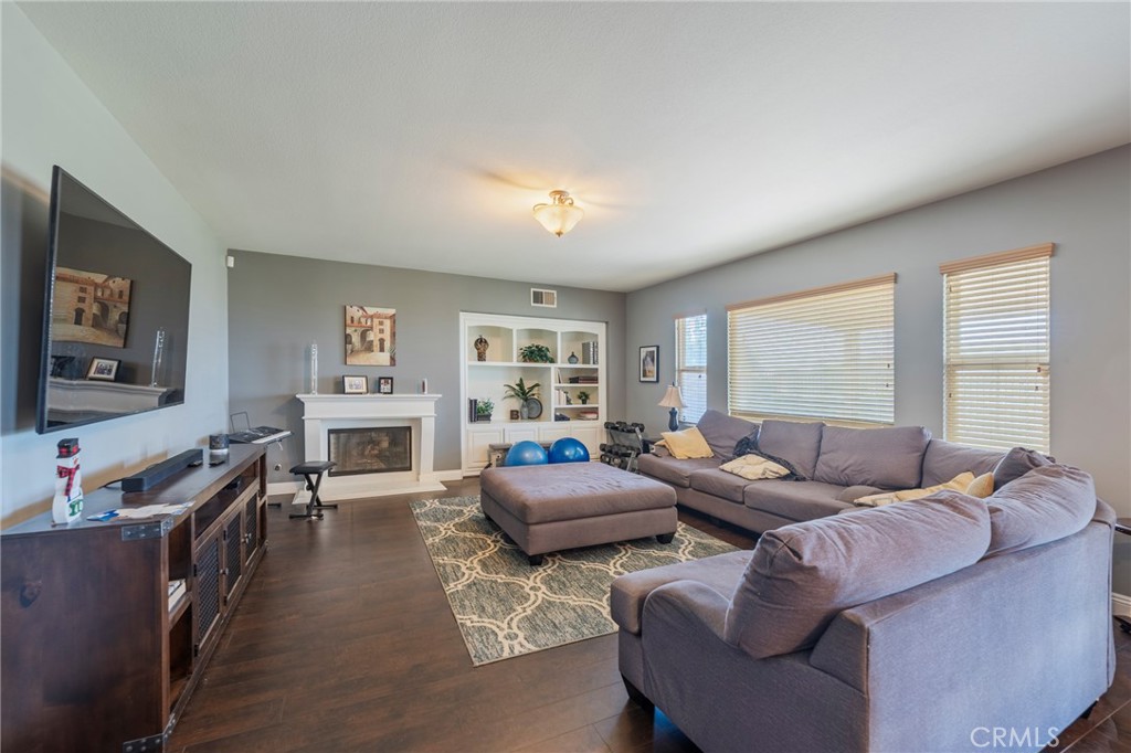 17073 Spring Canyon Place Riverside, CA 92503 - Photo 13 of 43 a living room with furniture and a flat screen tv