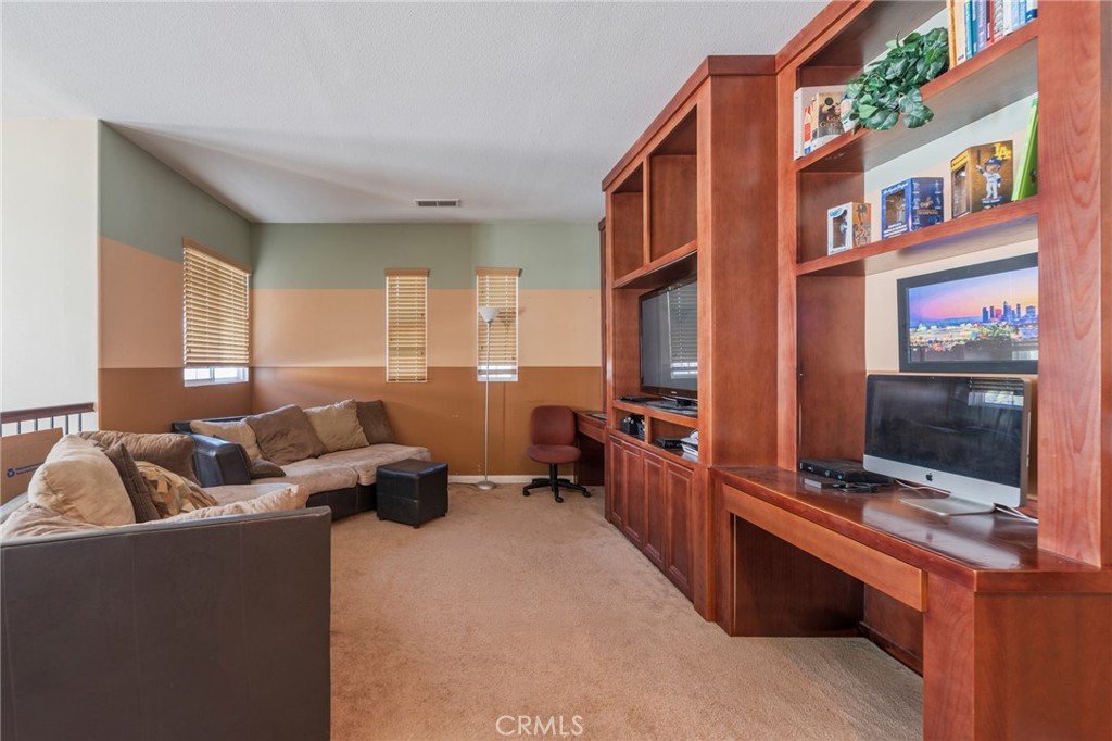 17073 Spring Canyon Place Riverside, CA 92503 - Photo 15 of 43 a living room with furniture and a flat screen tv