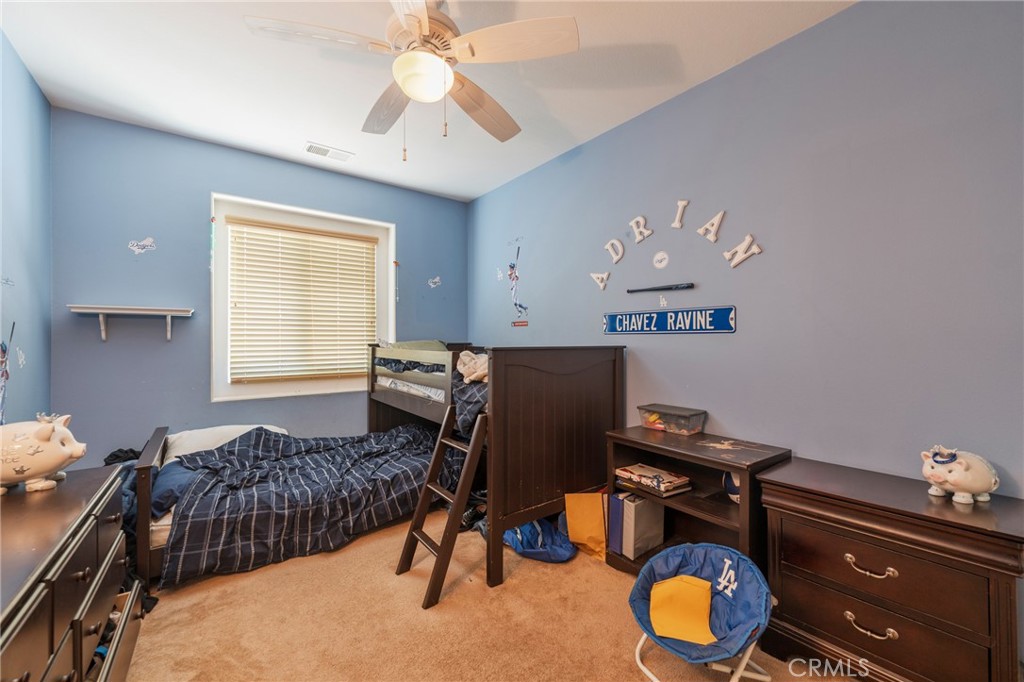 17073 Spring Canyon Place Riverside, CA 92503 - Photo 21 of 43 a bedroom with a bed and a chandelier
