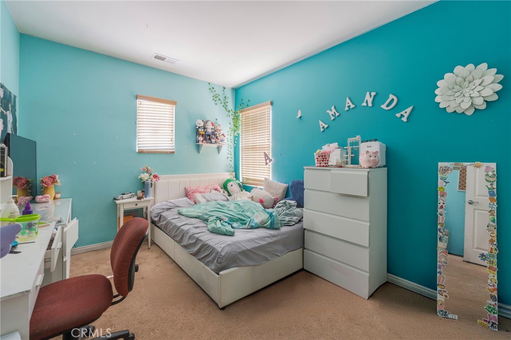 17073 Spring Canyon Place Riverside, CA 92503 - Photo 23 of 43 a bedroom with a bed and a chair