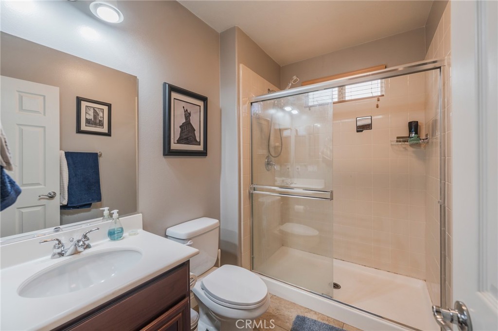 17073 Spring Canyon Place Riverside, CA 92503 - Photo 24 of 43 a bathroom with a sink mirror toilet and shower