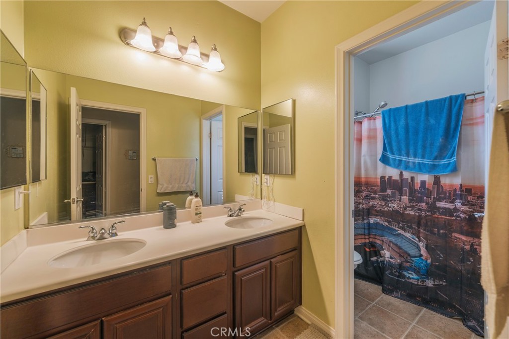 17073 Spring Canyon Place Riverside, CA 92503 - Photo 25 of 43 a bathroom with a sink and a mirror