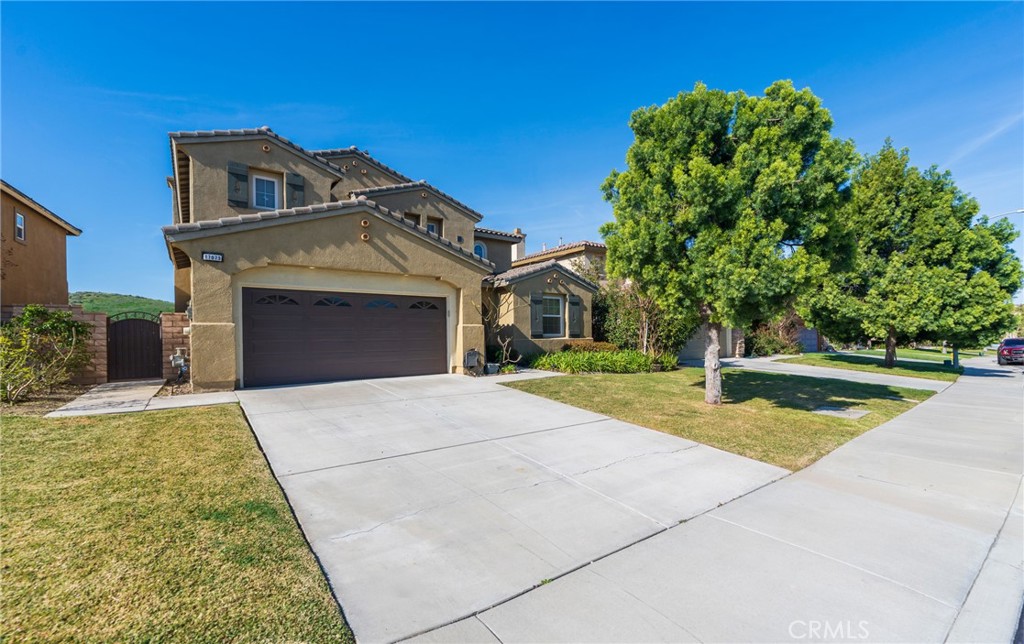 17073 Spring Canyon Place Riverside, CA 92503 - Photo 3 of 43 a front view of a house with yard