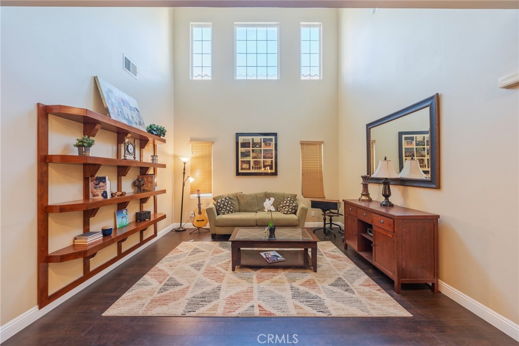 17073 Spring Canyon Place Riverside, CA 92503 - Photo 4 of 43 a living room with furniture and a book shelf