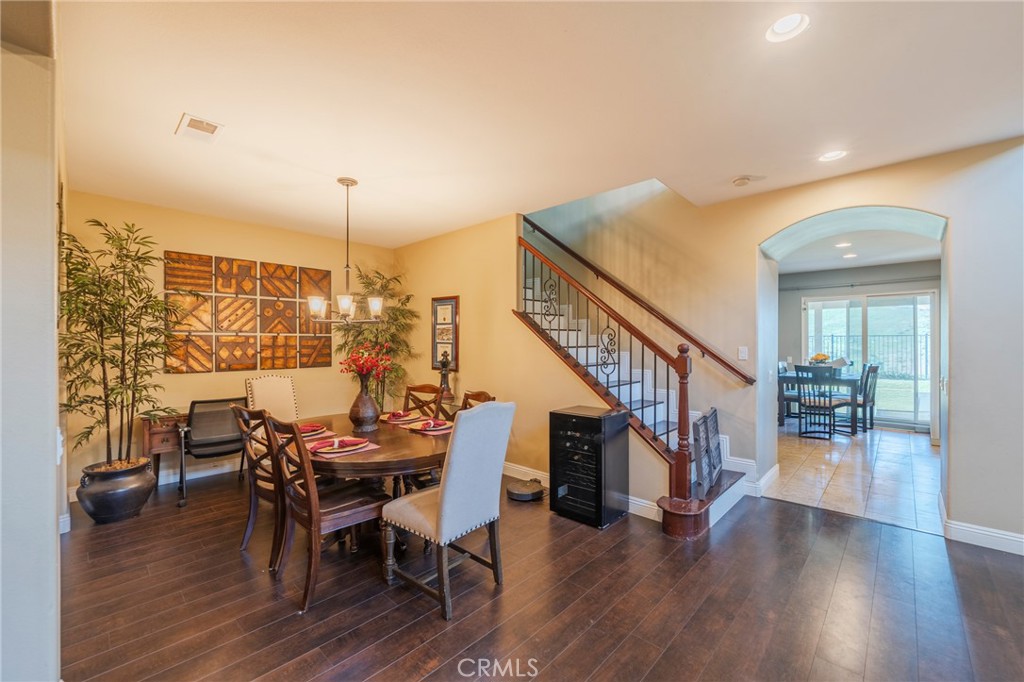 17073 Spring Canyon Place Riverside, CA 92503 - Photo 5 of 43 a dining room with furniture entryway and wooden floor