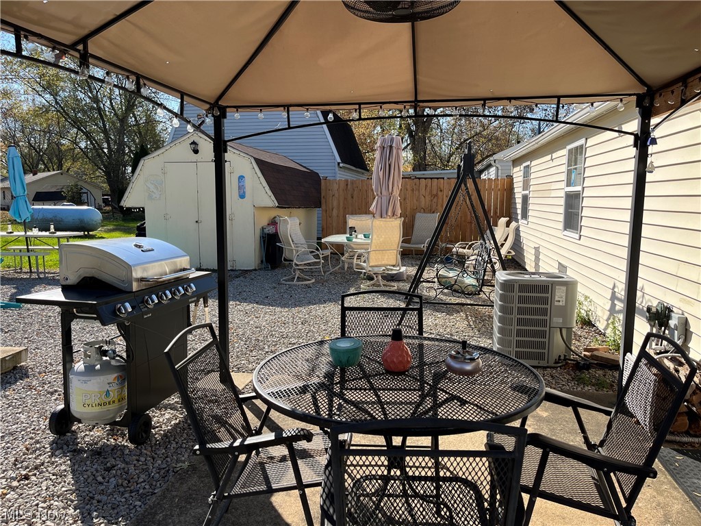 4972 West Fremont Road Port Clinton, OH 43452 - Photo 23 of 29 View of patio / terrace featuring grilling area, a storage shed, a gazebo, and central AC