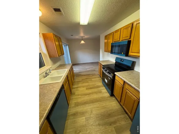 a kitchen with a sink and a microwave