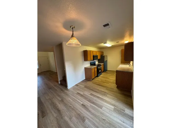 a view of a kitchen from the hallway