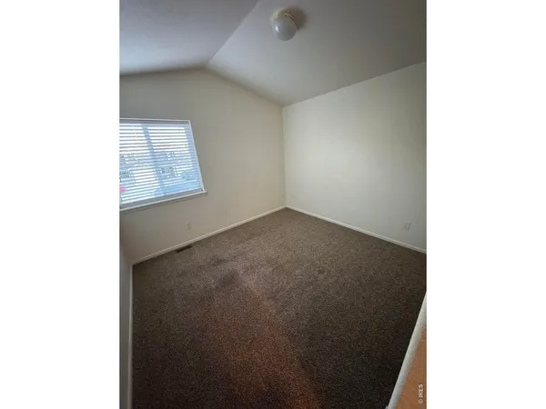 a view of an empty room with windows