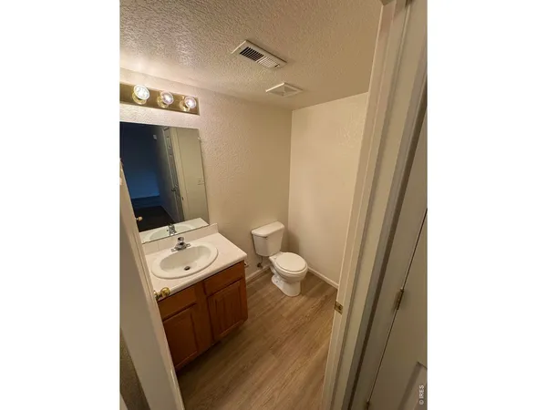 a bathroom with a toilet a sink and a mirror