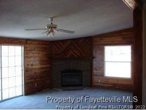 272 Line Road Cameron, NC 28326 - Photo 11 of 25 a living room with a fireplace and a window