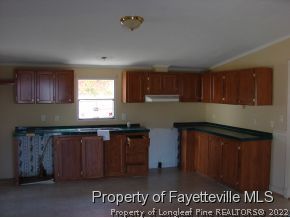 272 Line Road Cameron, NC 28326 - Photo 12 of 25 a kitchen with kitchen island granite countertop a sink cabinets and wooden floor